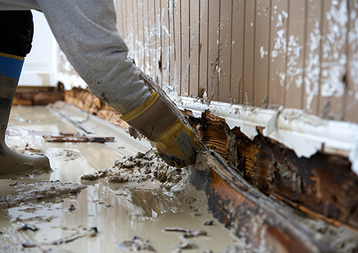 person removing water-damaged materials
